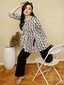 Woman wearing a brown indian kurti for women by Nishtha Chadda