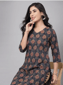 Woman wearing a red indian kurti for women by Nishtha Chadda