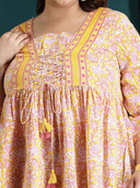 Woman wearing a maroon indian kurti for women by Nishtha Chadda