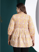 Woman wearing a maroon indian kurti for women by Nishtha Chadda
