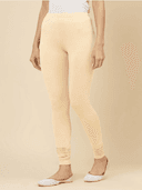 Woman wearing a beige kurti set with dupatta by Nishtha Chadda