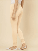 Woman wearing a beige kurti set with dupatta by Nishtha Chadda