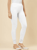 Woman wearing a beige kurti set with dupatta by Nishtha Chadda