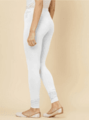 Woman wearing a beige kurti set with dupatta by Nishtha Chadda