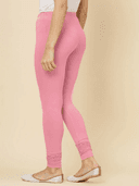 Woman wearing a beige kurti set with dupatta by Nishtha Chadda