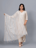 Woman wearing a grey kurti set with dupatta by Nishtha Chadda