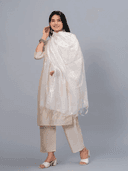 Woman wearing a grey kurti set with dupatta by Nishtha Chadda