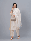 Woman wearing a grey kurti set with dupatta by Nishtha Chadda