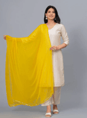 Woman wearing a grey kurti set with dupatta by Nishtha Chadda