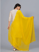 Woman wearing a grey kurti set with dupatta by Nishtha Chadda