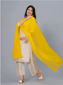 Woman wearing a grey kurti set with dupatta by Nishtha Chadda