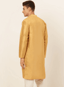 Model wearing a mustard party wear kurta by Nishtha Chadda