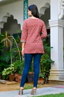 Woman wearing a black kurti set with dupatta by Nishtha Chadda