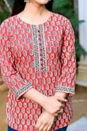 Woman wearing a black kurti set with dupatta by Nishtha Chadda