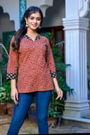 Woman wearing a navy kurti set with dupatta by Nishtha Chadda