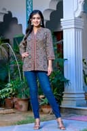 Woman wearing a red kurti set with dupatta by Nishtha Chadda
