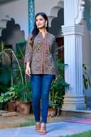 Woman wearing a red kurti set with dupatta by Nishtha Chadda