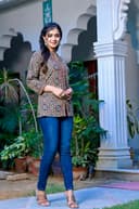 Woman wearing a red kurti set with dupatta by Nishtha Chadda