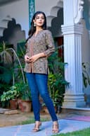 Woman wearing a red kurti set with dupatta by Nishtha Chadda