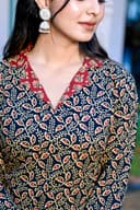 Woman wearing a navy kurti set with dupatta by Nishtha Chadda