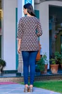 Woman wearing a navy kurti set with dupatta by Nishtha Chadda
