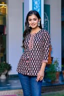 Woman wearing a navy kurti set with dupatta by Nishtha Chadda