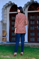Woman wearing a black kurti set with dupatta by Nishtha Chadda