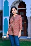 Woman wearing a black kurti set with dupatta by Nishtha Chadda