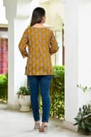 Woman wearing a brown kurti set with dupatta by Nishtha Chadda