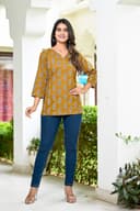 Woman wearing a brown kurti set with dupatta by Nishtha Chadda