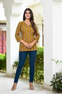 Woman wearing a brown kurti set with dupatta by Nishtha Chadda