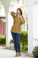 Woman wearing a olive kurti set with dupatta by Nishtha Chadda