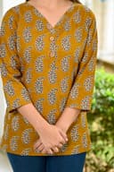 Woman wearing a olive kurti set with dupatta by Nishtha Chadda