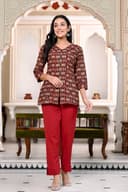 Woman wearing a maroon kurti set with dupatta by Nishtha Chadda