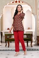 Woman wearing a maroon kurti set with dupatta by Nishtha Chadda