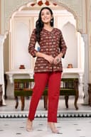 Woman wearing a maroon kurti set with dupatta by Nishtha Chadda