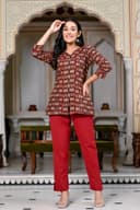 Woman wearing a maroon kurti set with dupatta by Nishtha Chadda