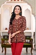 Woman wearing a maroon kurti set with dupatta by Nishtha Chadda