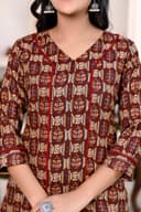 Woman wearing a maroon kurti set with dupatta by Nishtha Chadda