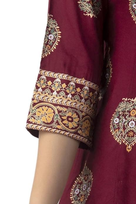 Woman wearing a maroon party wear ethnic kurta style by Nishtha Chadda