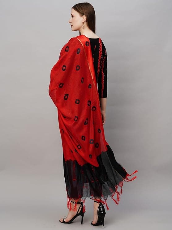 Woman wearing a red party wear ethnic kurta style by Nishtha Chadda