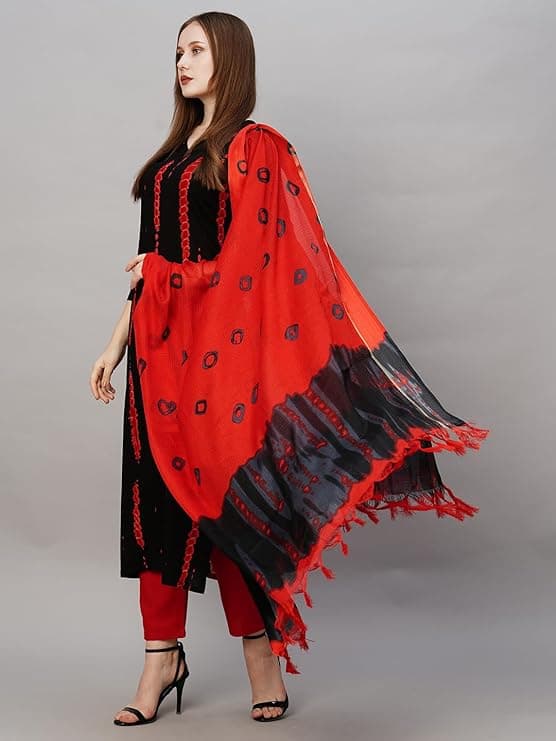 Woman wearing a red party wear ethnic kurta style by Nishtha Chadda