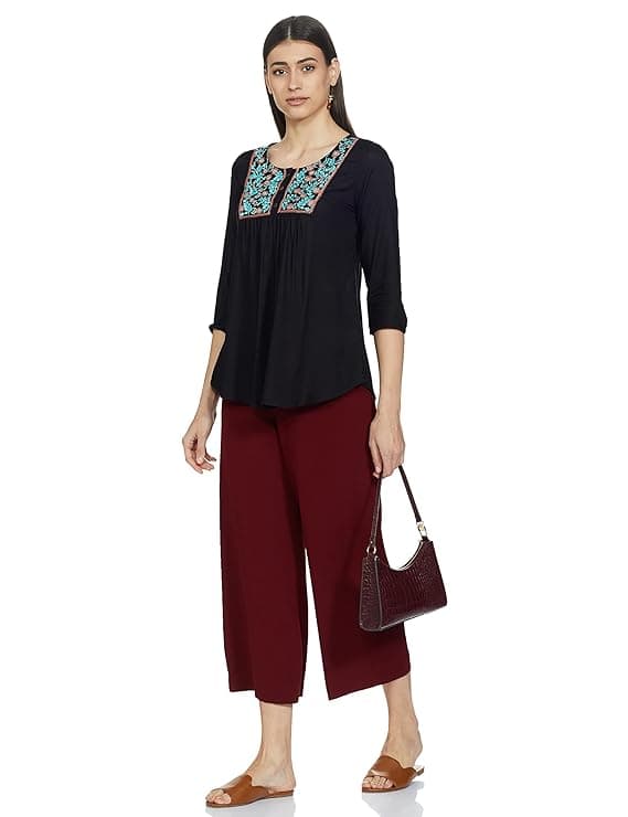 Woman wearing a maroon party wear ethnic kurta style by Nishtha Chadda