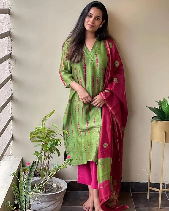 Woman wearing a maroon party wear ethnic kurta style by Nishtha Chadda