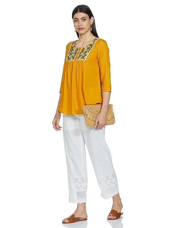 Woman wearing a mustard party wear ethnic kurta style by Nishtha Chadda