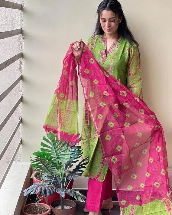 Woman wearing a red party wear ethnic kurta style by Nishtha Chadda