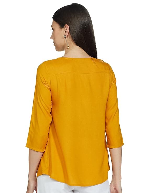 Woman wearing a mustard party wear ethnic kurta style by Nishtha Chadda