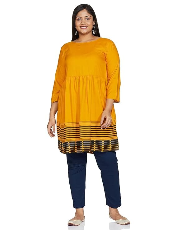 Woman wearing a mustard party wear ethnic kurta style by Nishtha Chadda