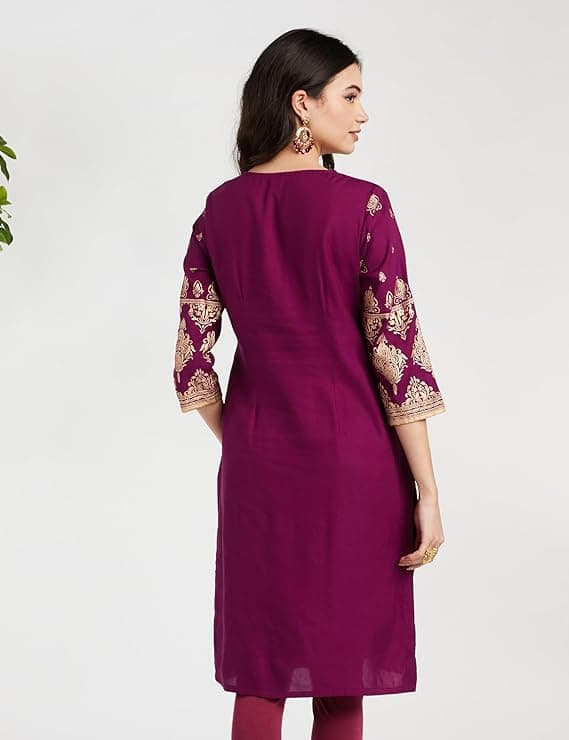 Woman wearing a maroon party wear ethnic kurta style by Nishtha Chadda