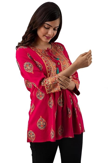 Woman wearing a red party wear ethnic kurta style by Nishtha Chadda